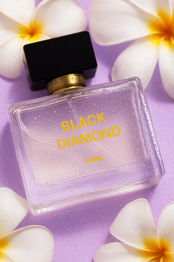 Gleaming Beauty Black Diamond 50 ml perfume with white flowers on lilac background, long lasting floral women’s scent in Pakistan.