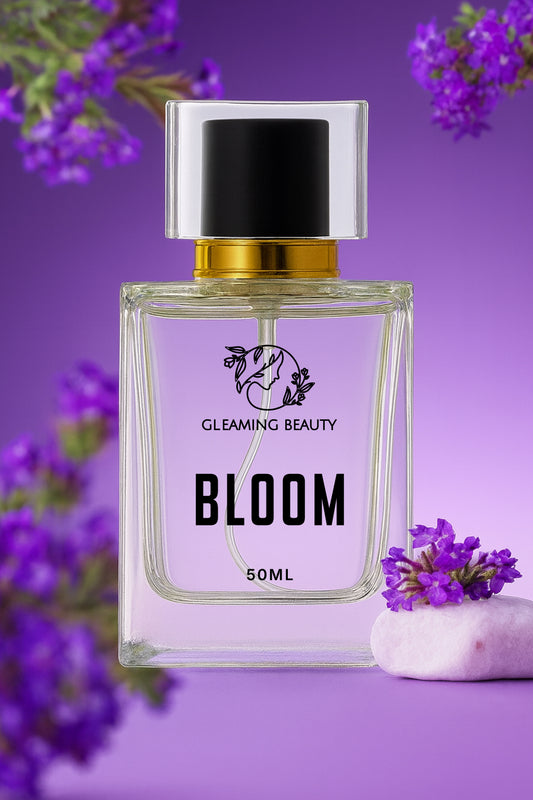 Perfume bottle labeled 'Bloom' by Gleaming Beauty on a purple background with flowers.
