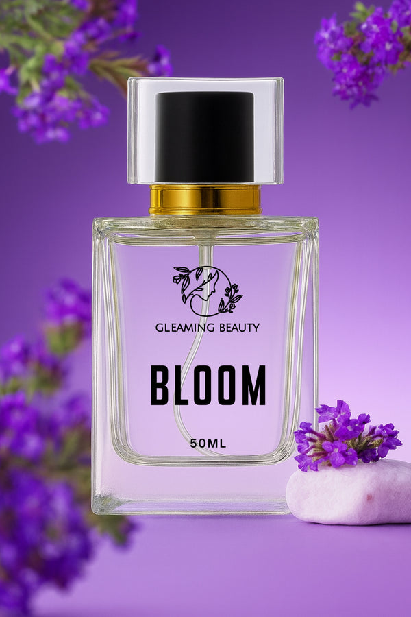 Perfume bottle labeled 'Bloom' by Gleaming Beauty on a purple background with flowers.